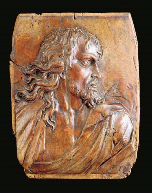 A CARVED WOOD PLAQUE OF A MAN IN PROFILE