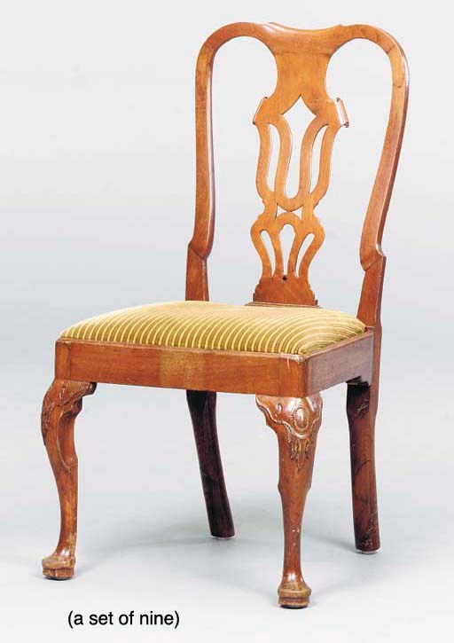 A SET OF NINE ENGLISH PROVINCIAL WALNUT DINING CHAIRS,