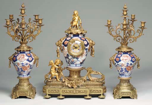 A NAPOLEON III GILT BRONZE AND EXPORT PORCELAIN THREE PIECE GARNITURE SET,