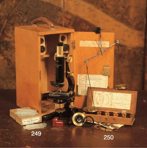 AN ENGLISH OAK MICROSCOPE CASE ENCLOSING A MICROSCOPE