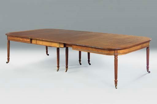 A REGENCY OAK EXTENDING DINING-TABLE