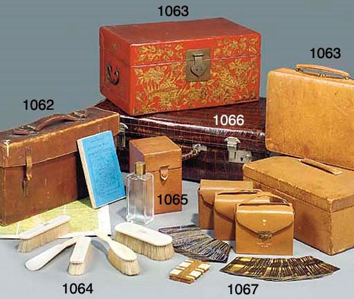 A SET OF FOUR GLASS SCENT-BOTTLES MOUNTED IN PIG SKIN TRAVELLING CASE