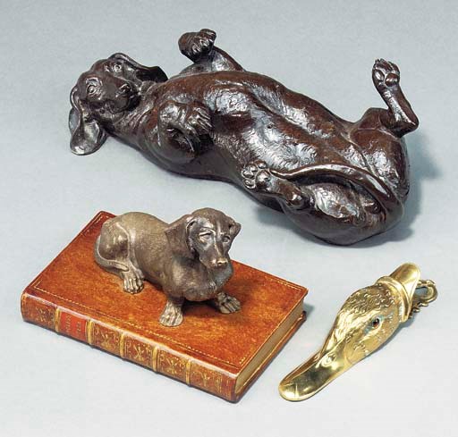 A BRONZE PATINATED COLD CAST RESIN MODEL OF A DACHSHUND