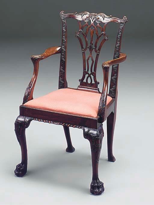 A CARVED MAHOGANY OPEN ARMCHAIR