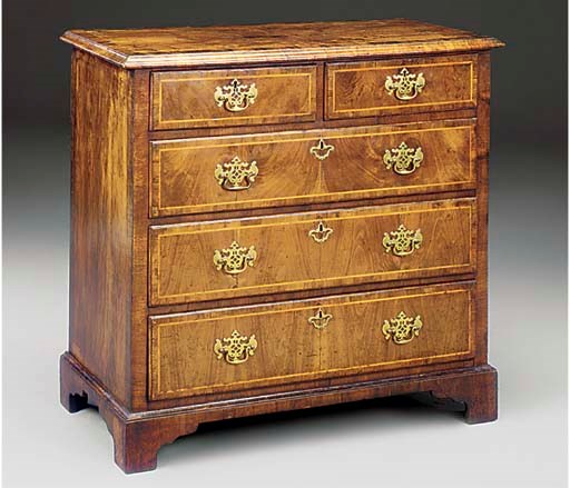 AN ENGLISH WALNUT CHEST OF DRAWERS