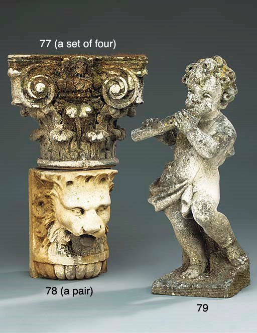 A pair of carved stone lion's head corbels