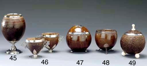 A SILVER-MOUNTED CARVED COCONUT CUP