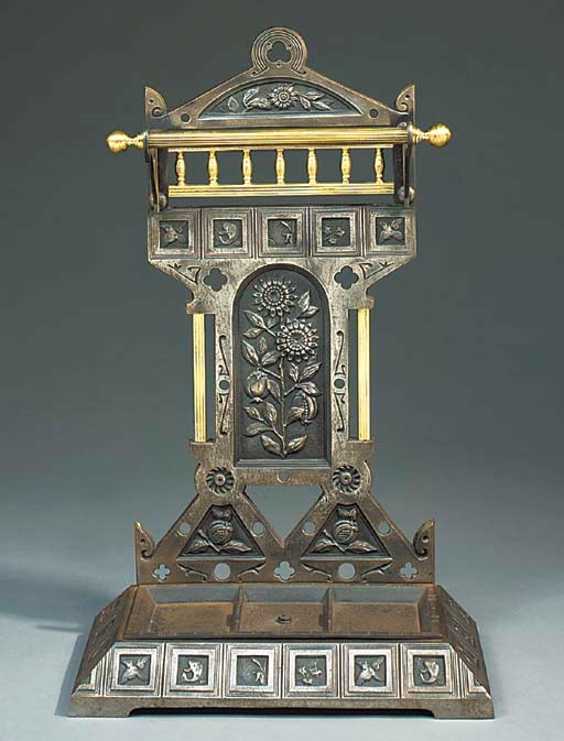 AN ARTS AND CRAFTS CAST IRON AND BRASS WALKING STICK/UMBRELLA STAND