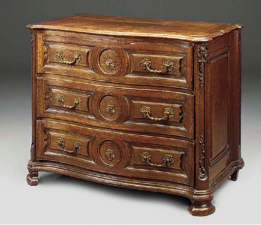 A DUTCH OAK SERPENTINE COMMODE
