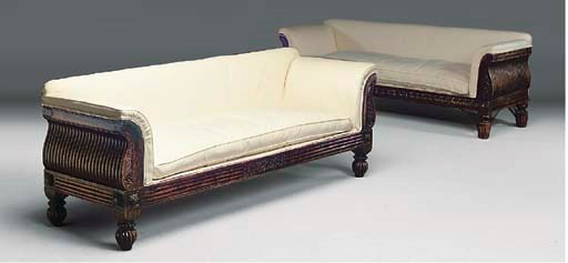 A MATCHED PAIR OF ANGLO INDIAN HARDWOOD AND CALICO UPHOLSTERED SOFAS
