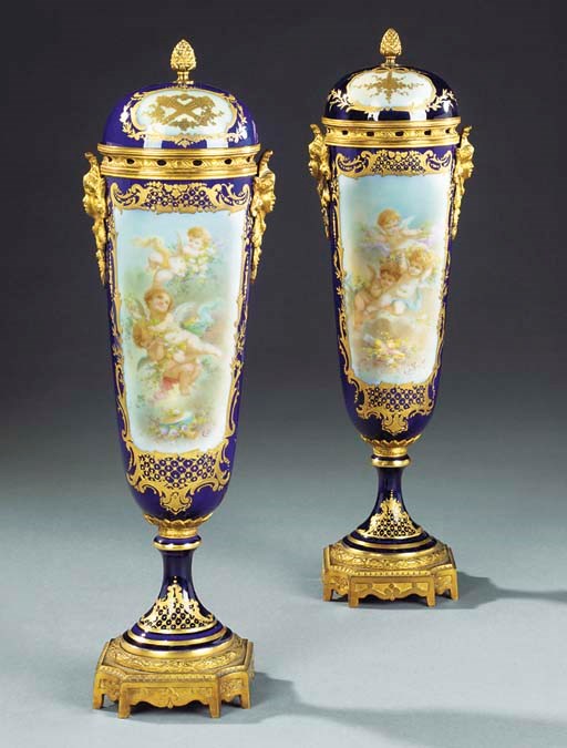 A PAIR OF FRENCH SEVRES STYLE GILT BRONZE AND PORCELAIN VASES AND COVERS
