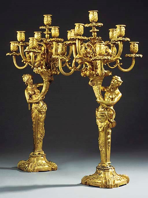 A PAIR OF CONTINENTAL GILT BRONZE NINE LIGHT FIGURAL CANDELABRA