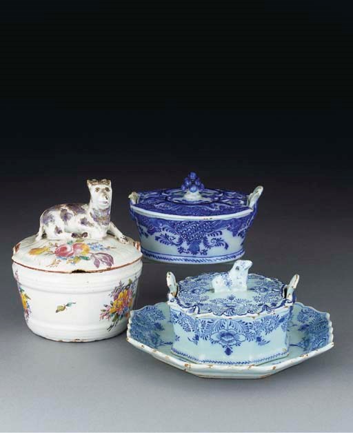 A Dutch Delft blue and white butter-tub cover and stand, a Dutch Delft butter-tub and cover and a North European butter-tub and cover
