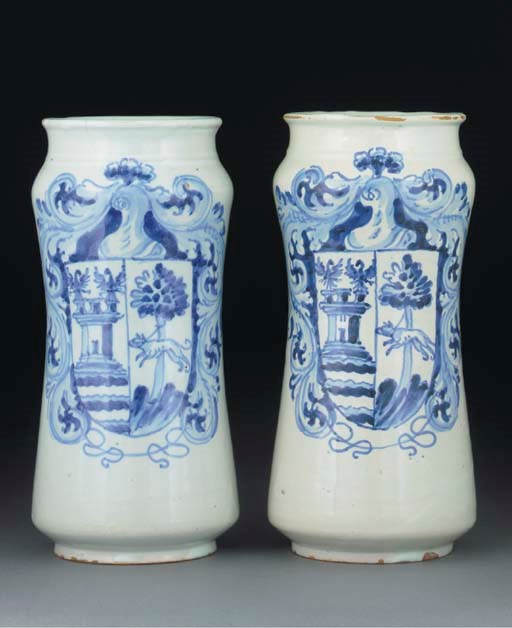 Two Spanish maiolica blue and white armorial albarelli