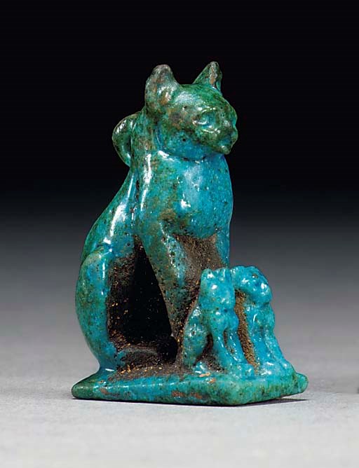 AN EGYPTIAN FAIENCE SEATED CAT WITH KITTENS