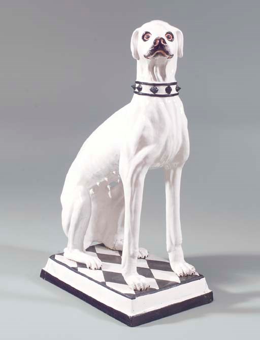 A MAJOLICA MODEL OF A SEATED DOG,