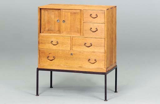 A WOOD TANSU ON A WROUGHT IRON BASE,