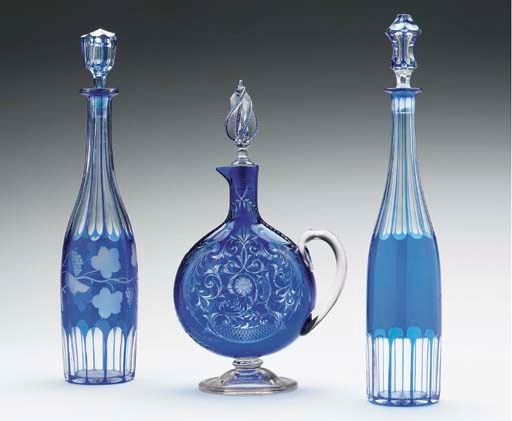 THREE CONTINENTAL BLUE-OVERLAY CUT-GLASS DECANTERS AND STOPPERS,