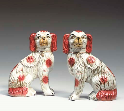 A PAIR OF PORCELAIN MODELS OF SEATED SPANIELS,