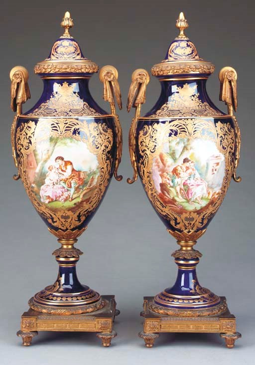A PAIR OF SEVRES STYLE COBALT GROUND PORCELAIN GILT BRONZE MOUNTED VASES AND COVERS,