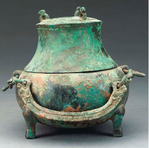 A SMALL ARCHAIC CHINESE BRONZE TRIPOD JAR AND COVER,