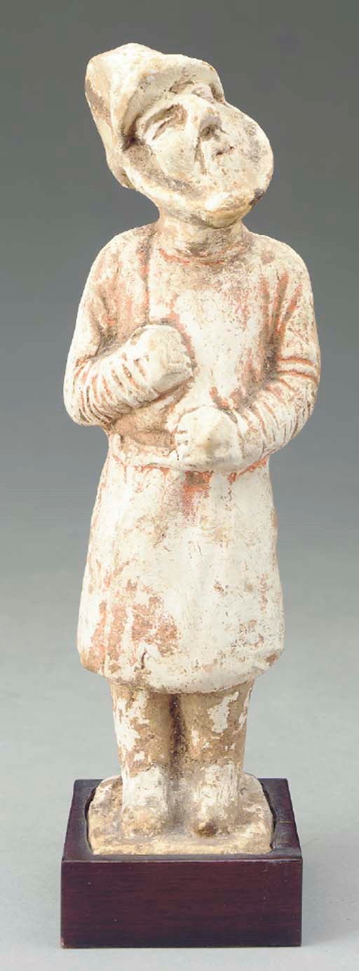 A CHINESE PAINTED POTTERY FIGURE OF A FOREIGNER,