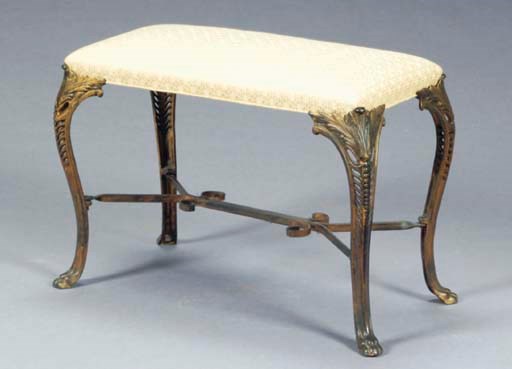 A GOLD-PAINTED METAL BENCH,
