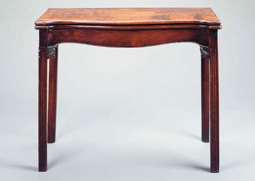 A GEORGE III MAHOGANY SERPENTINE FRONTED GAMES TABLE