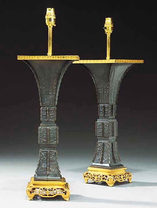 A PAIR OF GILT AND PATINATED BRONZE TABLE LAMPS