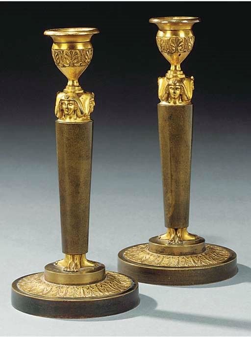 A PAIR OF EMPIRE ORMOLU AND BRONZE CANDLESTICKS