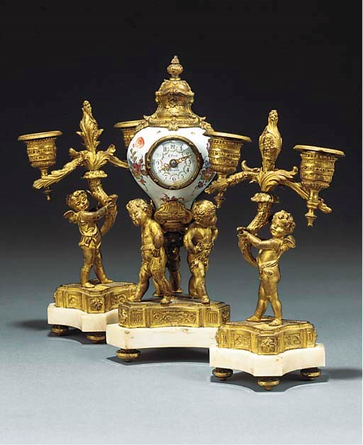 A FRENCH GILT METAL AND PORCELAIN MANTEL CLOCK AND GARNITURE