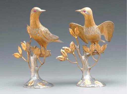 A PAIR OF MEXICAN SILVER AND PARCEL GILT BIRDS,