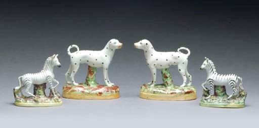 A PAIR OF STAFFORDSHIRE MODELS OF DALMATIONS TOGETHER WITH A PAIR OF EARTHENWARE ZEBRAS,