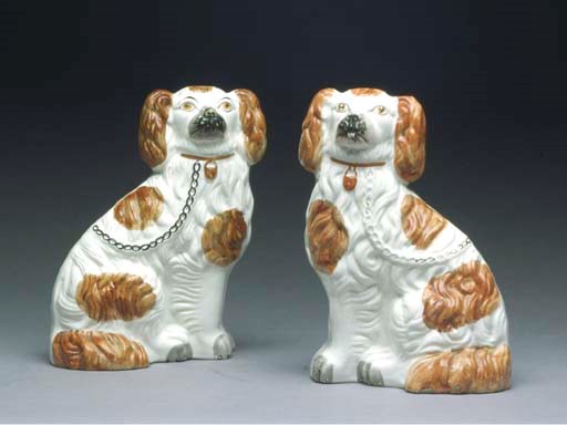 A PAIR OF STAFFORDSHIRE MODELS OF SPANIELS,