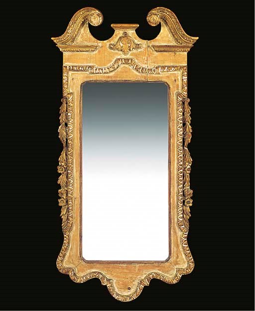 A PINE AND GILT-HEIGHTENED WALL MIRROR