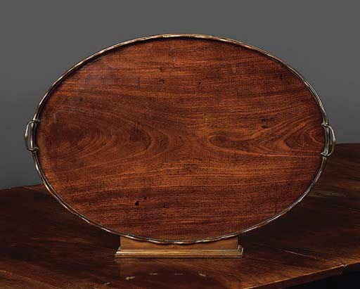 AN OVAL MAHOGANY TWO-HANDLE TRAY