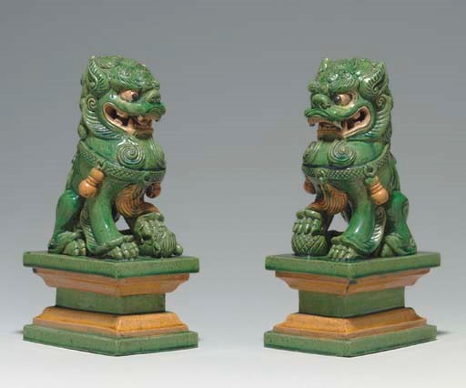 A PAIR OF GREEN, AMBER, CREAM-GLAZED FIGURES OF BUDDHISTIC LIONS