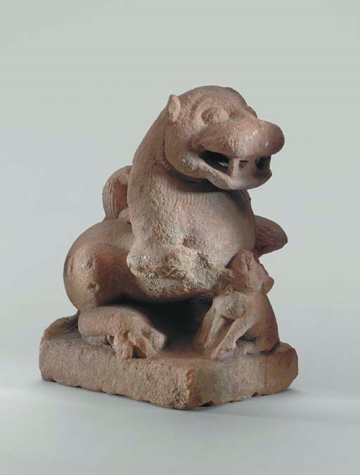 A Red Sandstone Figure of a Lion