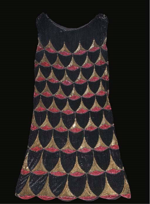 A beaded dress, the black cotton ground strewn with transparent bugle beads, worked with two columns of roses, 1920s; and another beaded dress, the ground worked in black sequins with bands of gilt and pink scallops, also 1920s 	 (2)