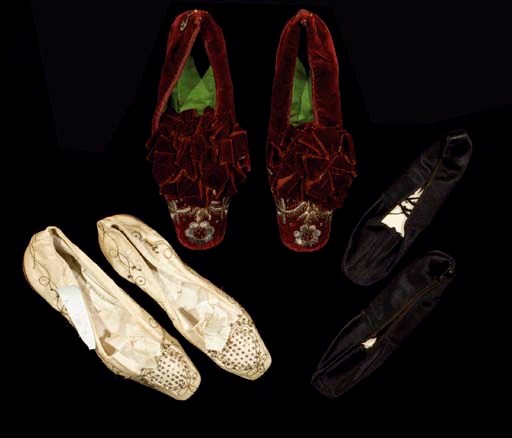 A pair of ivory satin dancing pumps, embroidered in gilt thread and trimmed with spangles, mid 19th century; another pair of dancing pumps of black satin for a child, 18cm long; and a third pair of crimson velvet red heeled lady's shoes, embroidered with silver flowers and trimmed with velvet ribbons, Turkish for the European market, 1870s
