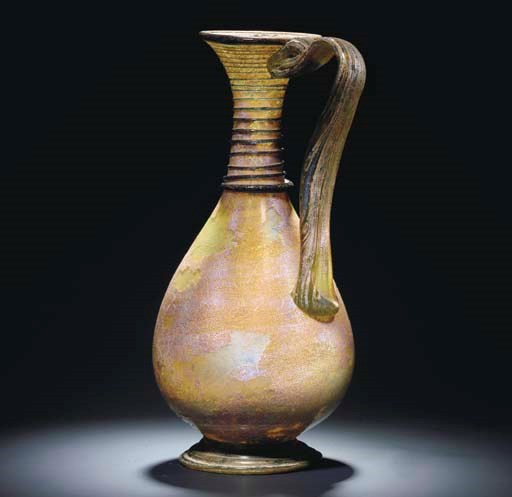A LARGE ROMAN GREEN GLASS JUG