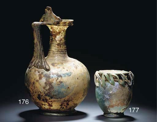 A LARGE ROMAN PALE GREEN GLASS JUG