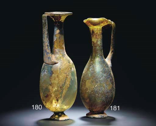 A ROMAN OLIVE GREEN GLASS JUG