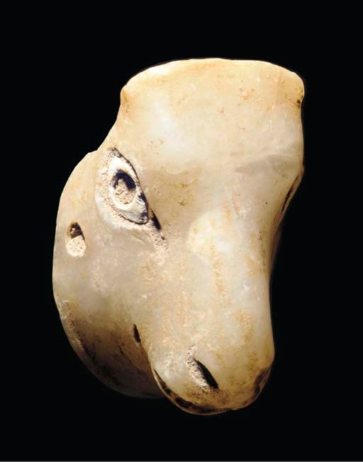 A MESOPOTAMIAN ALABASTER BULL HEAD ATTACHMENT