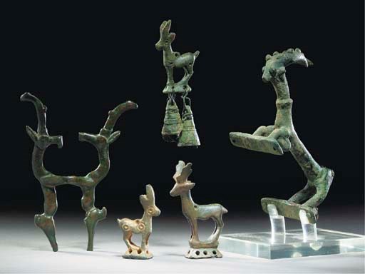 A PERSIAN BRONZE HANDLE IN THE FORM OF AN IBEX