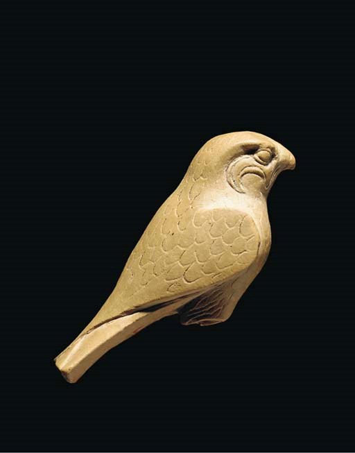 AN EGYPTIAN LIMESTONE HORUS FALCON