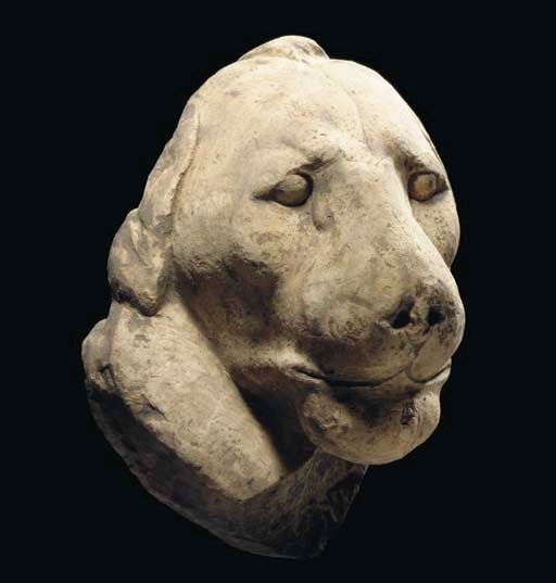 AN EGYPTIAN LIMESTONE HEAD OF A LION