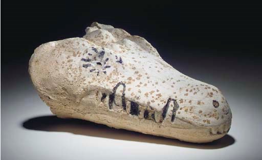 AN EGYPTIAN PLASTER CROCODILE MUMMY MASK