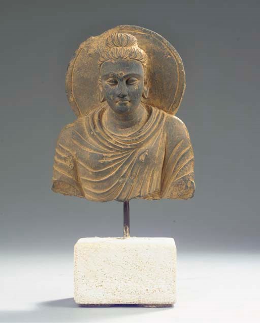 A Gandhara grey schist bust of Buddha sakyamuni