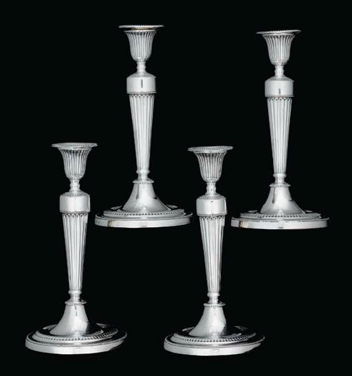A SET OF FOUR GEORGE III SILVER CANDLESTICKS